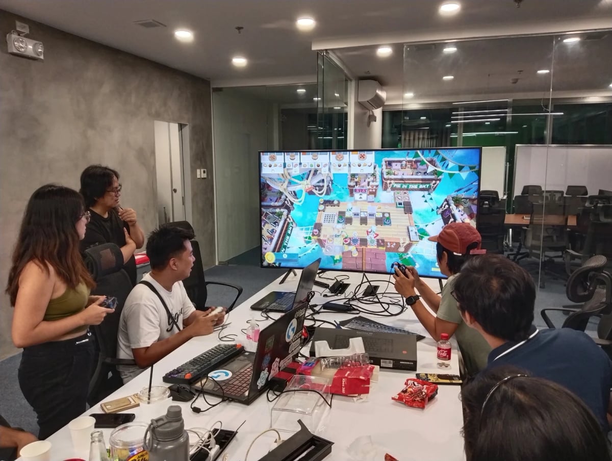 Full Scale employees gathered around a screen together during a company esports tournament