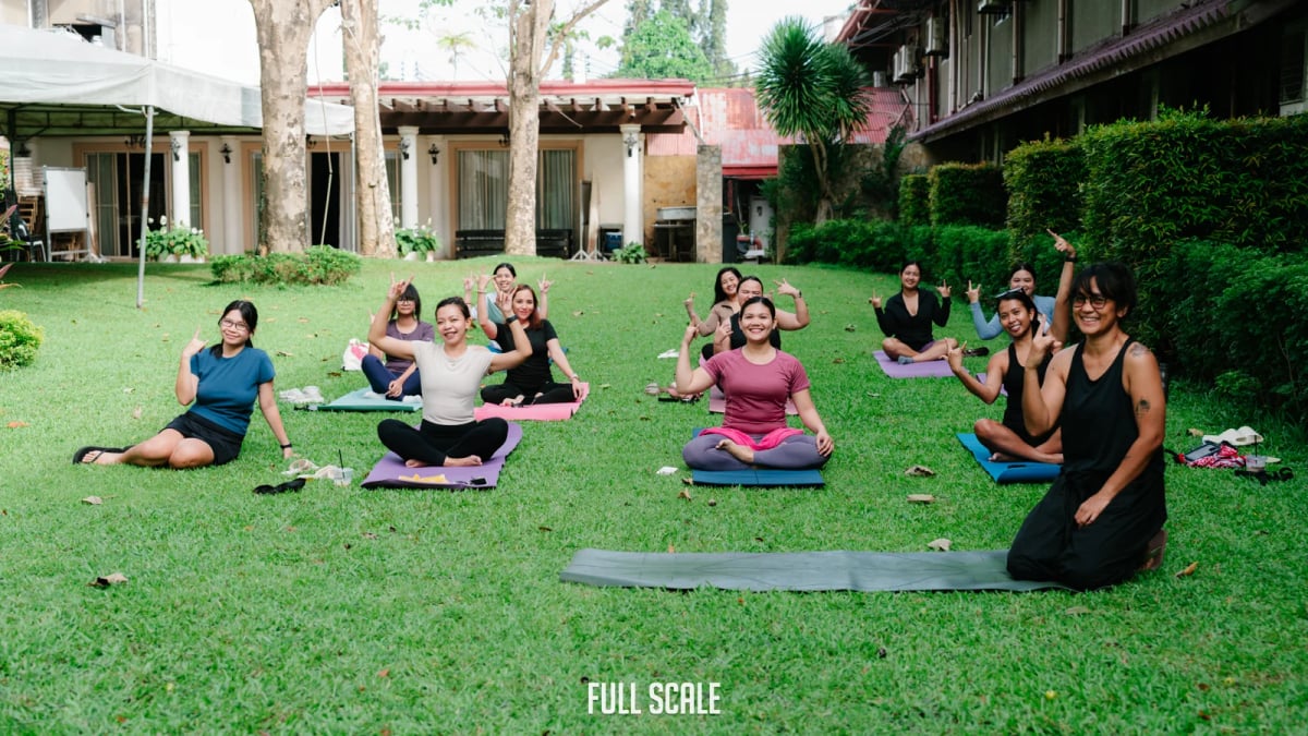 Full Scale employees during an outdoor yoga session at Wellness Day