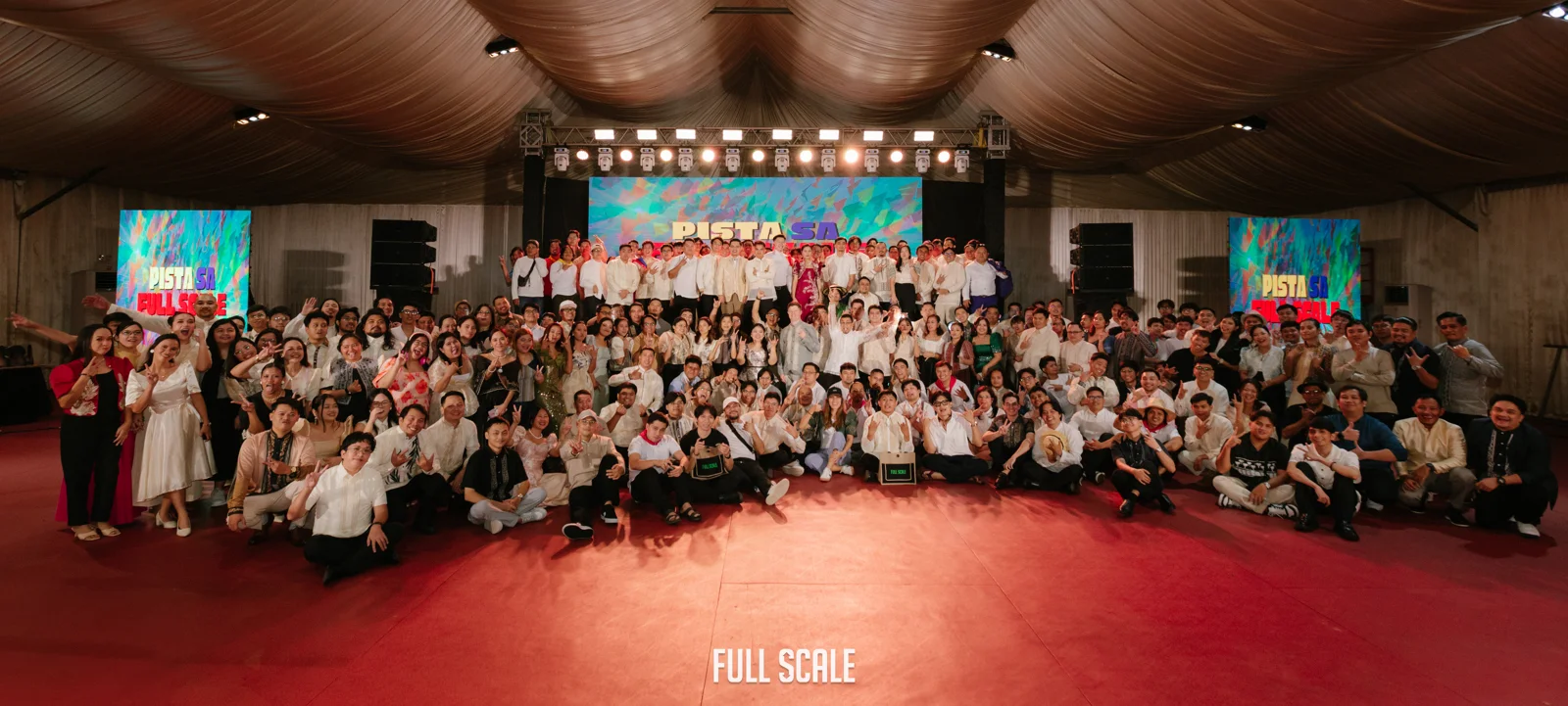 Full Scale employees dressed in Filipiniana attire posed together at the "Pista sa Full Scale" Year-End Party