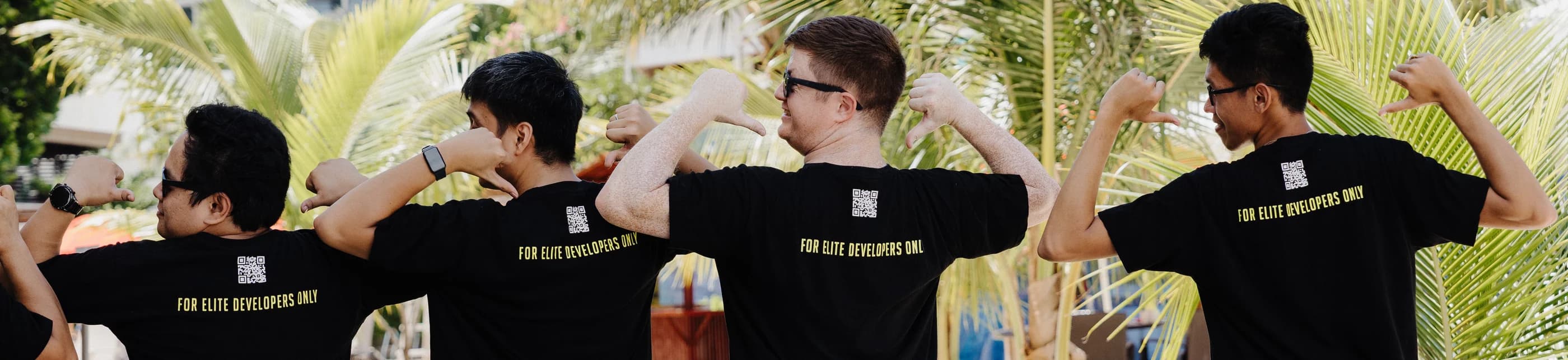 Full Scale engineers in company shirts that read For Elite Developers Only, each pointing at himself