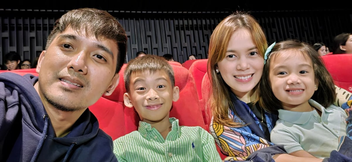 A Full Scale employee and family seated together before a performance of Shrek the Musical